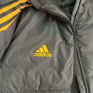 Adidas long puffer jacket. Black/gold/yellow size Large with a hoodie